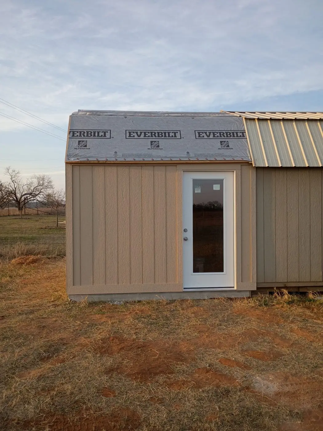 Finished portable building with metal roof and glass door