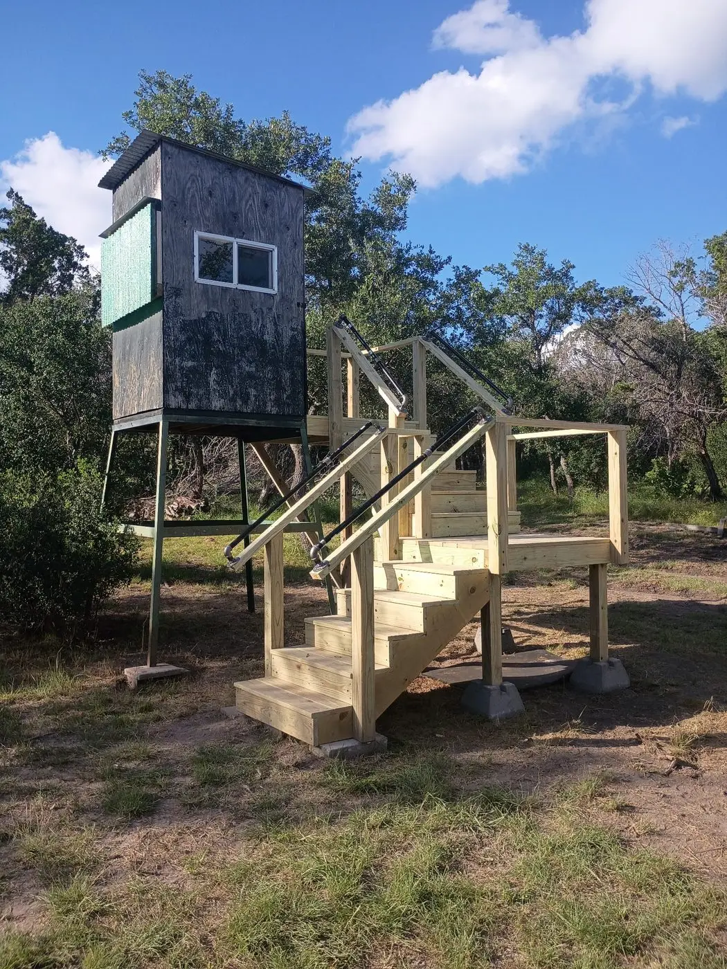 Custom-built elevated deer blind with stairs and railing